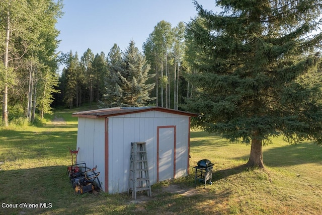 view of shed with a wooded view