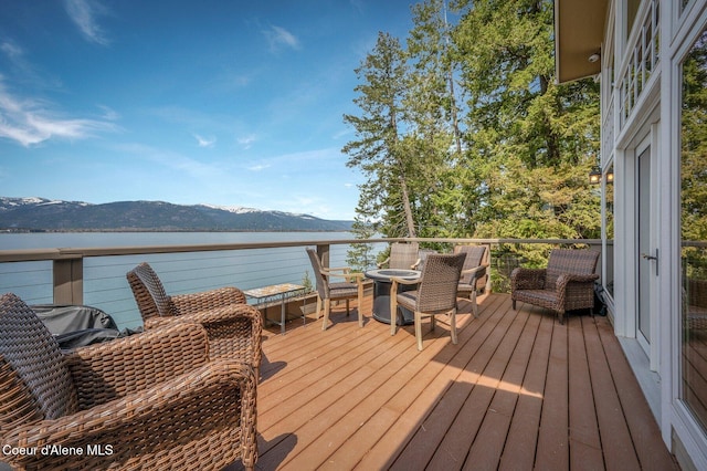 3765 Bottle Bay Rd, Sagle, ID 83860 - wooden terrace with a water and mountain view
