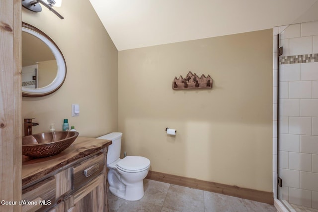 3765 Bottle Bay Rd, Sagle, ID 83860 - full bathroom featuring vanity, baseboards, tile patterned flooring, toilet, and a tile shower