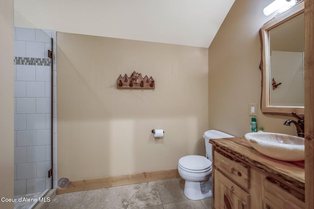 3765 Bottle Bay Rd, Sagle, ID 83860 - full bathroom with baseboards, toilet, vanity, tile patterned floors, and tiled shower