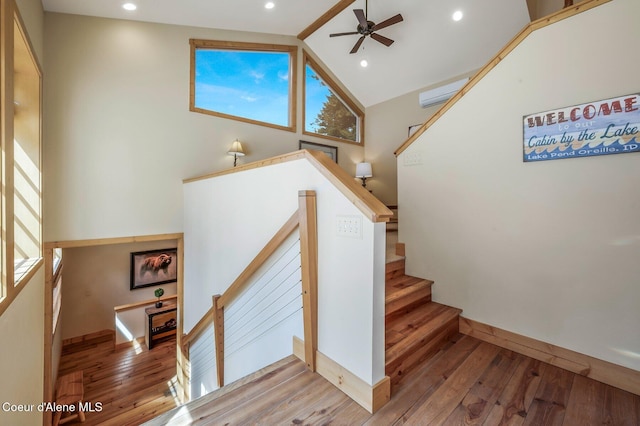 3765 Bottle Bay Rd, Sagle, ID 83860 - stairway with baseboards, a ceiling fan, recessed lighting, high vaulted ceiling, and hardwood / wood-style floors