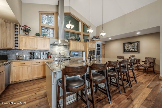 3765 Bottle Bay Rd, Sagle, ID 83860 - kitchen featuring high vaulted ceiling, light brown cabinets, backsplash, and appliances with stainless steel finishes