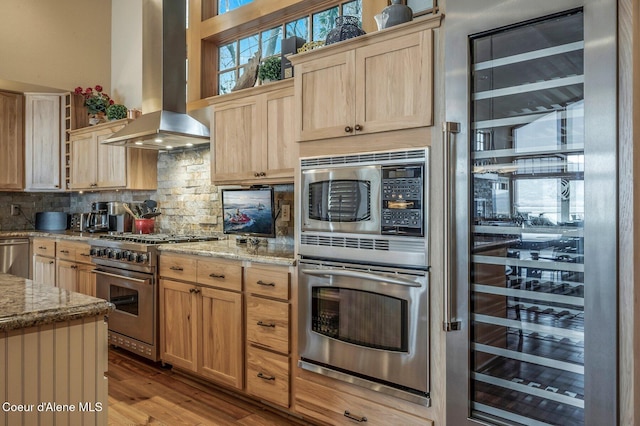 3765 Bottle Bay Rd, Sagle, ID 83860 - kitchen with wine cooler, light brown cabinets, island exhaust hood, and appliances with stainless steel finishes