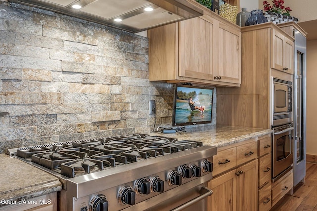 3765 Bottle Bay Rd, Sagle, ID 83860 - kitchen with custom exhaust hood, light brown cabinets, decorative backsplash, stainless steel appliances, and wood finished floors