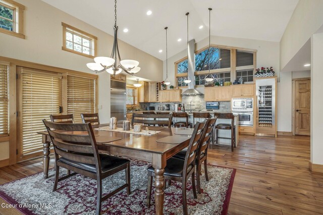 3765 Bottle Bay Rd, Sagle, ID 83860 - dining room with baseboards, a chandelier, recessed lighting, dark wood-type flooring, and high vaulted ceiling