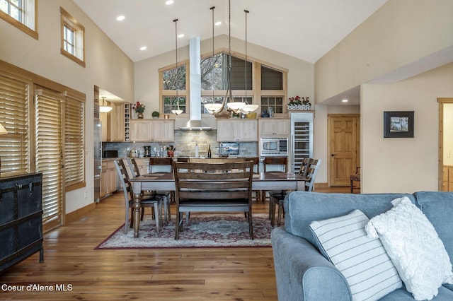 3765 Bottle Bay Rd, Sagle, ID 83860 - dining room featuring high vaulted ceiling, a notable chandelier, and wood finished floors