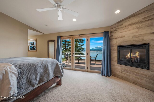 3765 Bottle Bay Rd, Sagle, ID 83860 - bedroom with a glass covered fireplace, access to outside, vaulted ceiling, a ceiling fan, and carpet