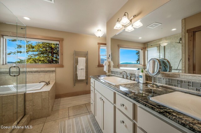 3765 Bottle Bay Rd, Sagle, ID 83860 - full bathroom featuring a shower stall, visible vents, a sink, tile patterned floors, and decorative backsplash