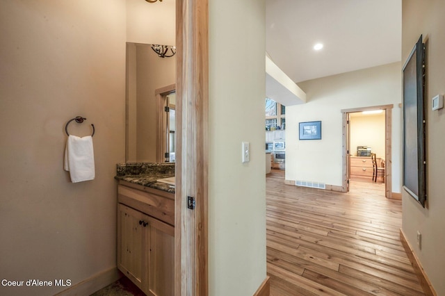 3765 Bottle Bay Rd, Sagle, ID 83860 - hall with visible vents, baseboards, and light wood-style flooring