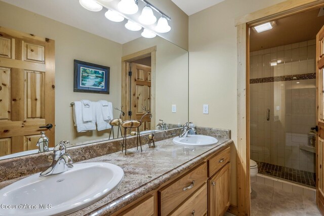 3765 Bottle Bay Rd, Sagle, ID 83860 - full bathroom with toilet, a stall shower, a sink, and tile patterned floors