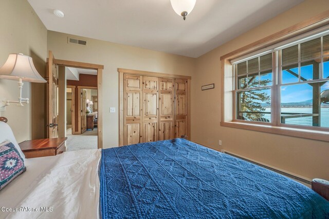 3765 Bottle Bay Rd, Sagle, ID 83860 - bedroom featuring baseboard heating, a closet, and visible vents