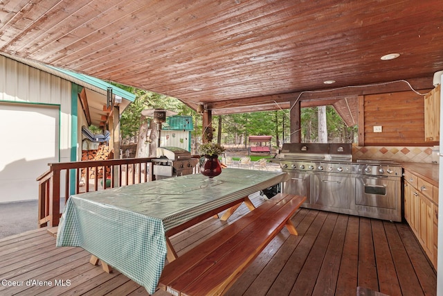 wooden terrace featuring grilling area and outdoor dining area