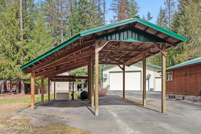 view of vehicle parking with a detached garage and heating fuel