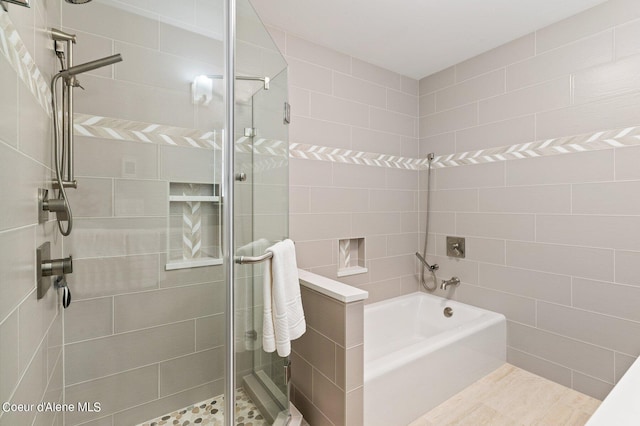 full bathroom with a stall shower and a bathing tub