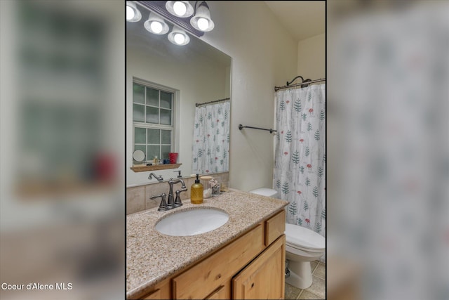 full bathroom with toilet, vanity, and tile patterned flooring