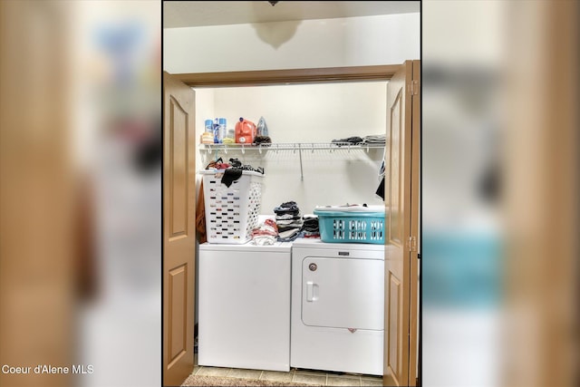 clothes washing area with separate washer and dryer