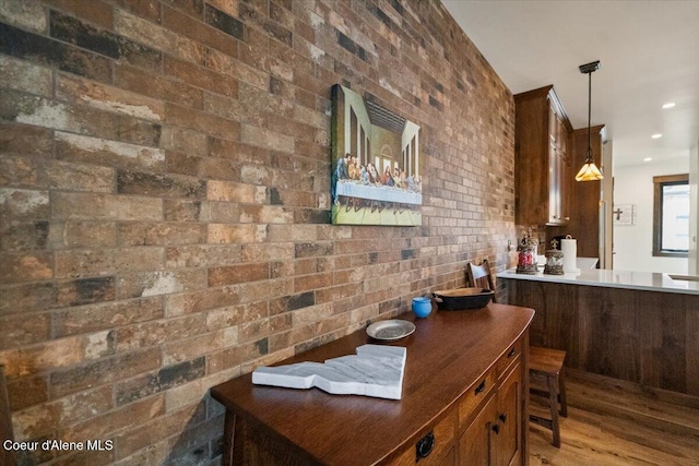 interior space featuring brick wall, wood finished floors, and recessed lighting