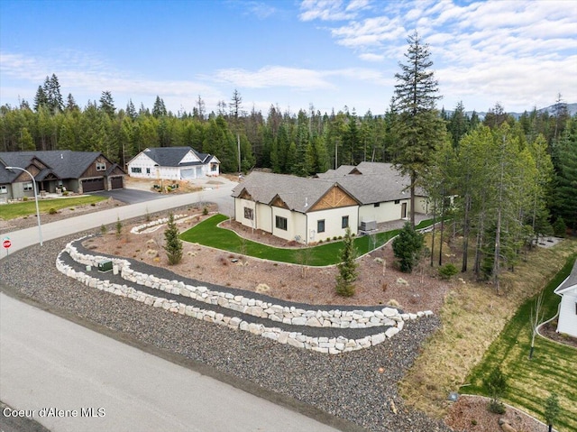 birds eye view of property featuring a view of trees