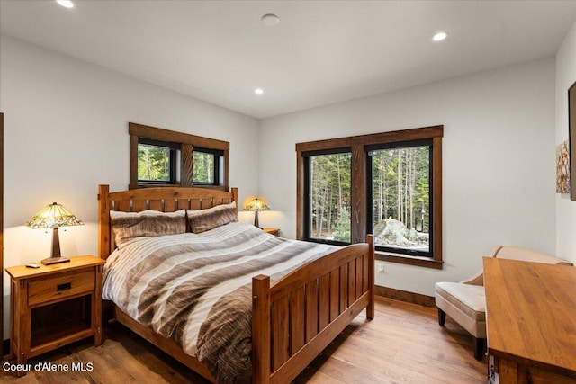 bedroom featuring recessed lighting, light wood-style floors, and baseboards