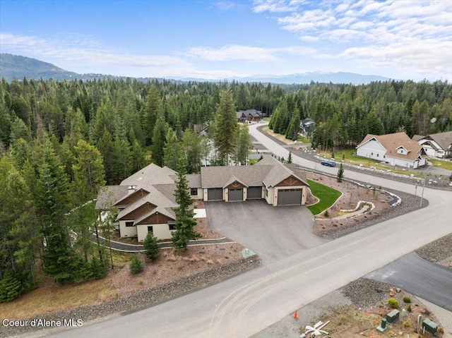 drone / aerial view featuring a forest view