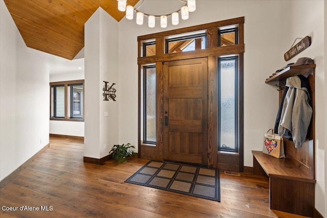 foyer entrance with wood-type flooring, baseboards, vaulted ceiling, and wood ceiling