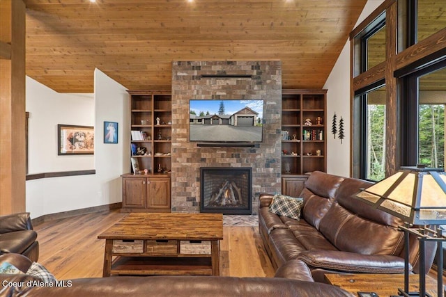 living area featuring built in features, wood finished floors, lofted ceiling, and wooden ceiling