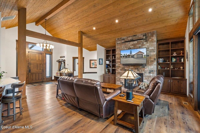 living area featuring built in features, a fireplace, wood ceiling, beamed ceiling, and hardwood / wood-style flooring