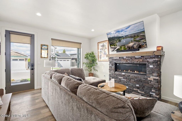 3242 N Rosalia Rd, Coeur Dalene, ID 83814 - living room featuring a healthy amount of sunlight, a stone fireplace, and wood finished floors