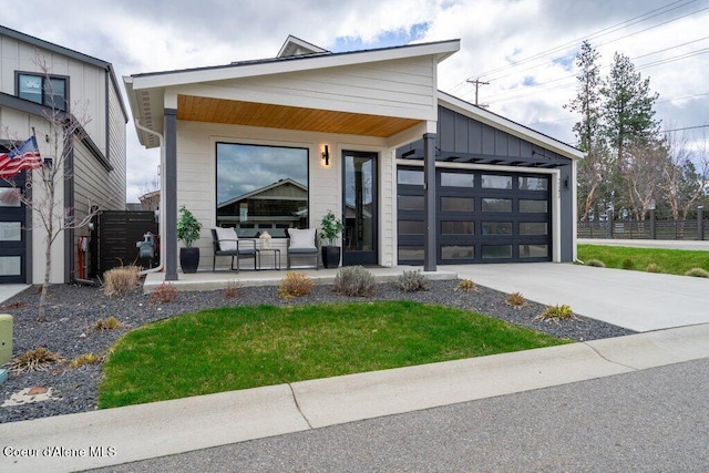 3242 N Rosalia Rd, Coeur Dalene, ID 83814 - modern home featuring a porch, fence, a garage, and driveway
