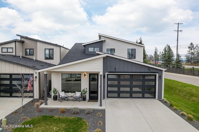 3242 N Rosalia Rd, Coeur Dalene, ID 83814 - modern home with concrete driveway, roof with shingles, board and batten siding, and a front lawn