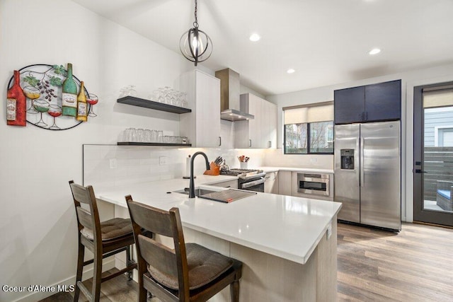 3242 N Rosalia Rd, Coeur Dalene, ID 83814 - kitchen featuring a peninsula, light countertops, open shelves, wall chimney exhaust hood, and appliances with stainless steel finishes