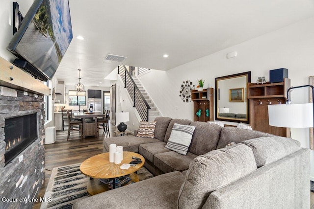 3242 N Rosalia Rd, Coeur Dalene, ID 83814 - living room featuring dark wood finished floors, visible vents, recessed lighting, a stone fireplace, and stairway