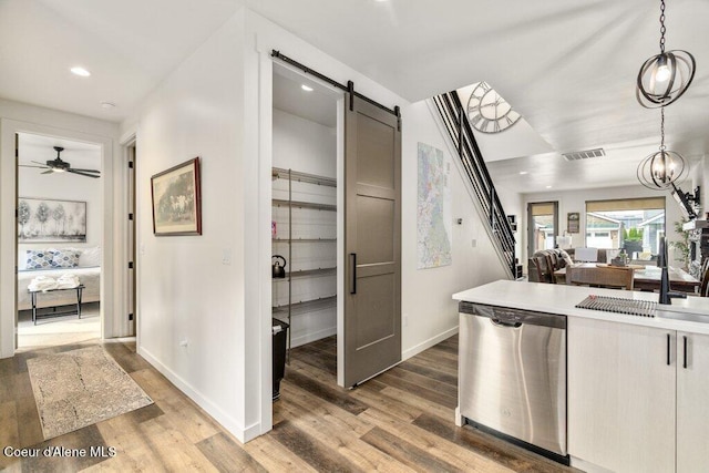 3242 N Rosalia Rd, Coeur Dalene, ID 83814 - kitchen with stainless steel dishwasher, visible vents, a barn door, a sink, and open floor plan