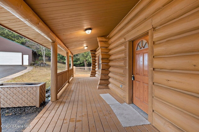 deck with covered porch and an outdoor structure