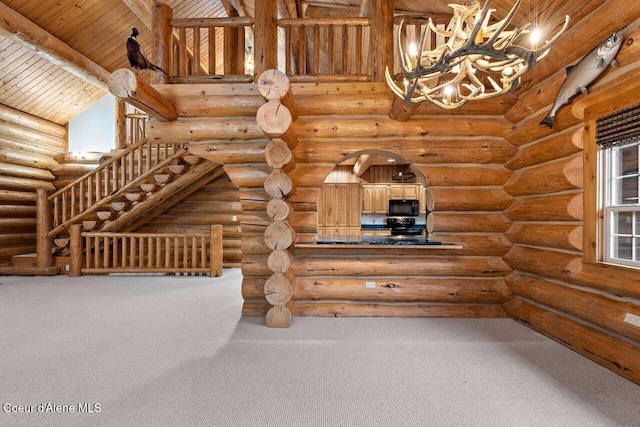 interior space with rustic walls, wooden ceiling, beam ceiling, carpet floors, and a notable chandelier