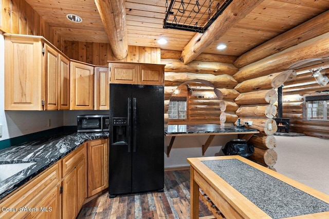 kitchen featuring wood ceiling, rustic walls, beamed ceiling, a wood stove, and black refrigerator with ice dispenser