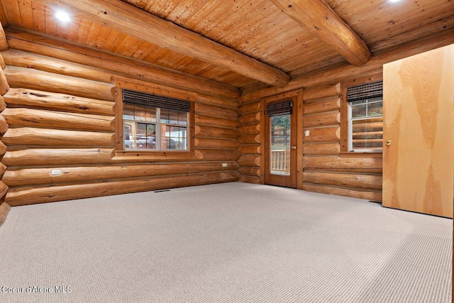 empty room with carpet flooring, wooden ceiling, beam ceiling, and plenty of natural light