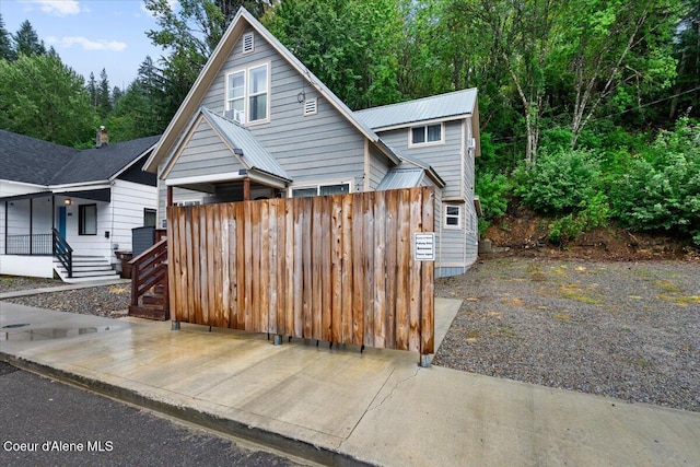 804 Residence St, Wallace, ID 83873 - view of front of home with metal roof and fence
