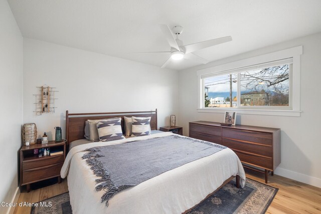 bedroom with baseboards, ceiling fan, and wood finished floors