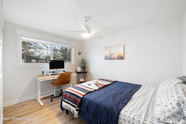 bedroom featuring light wood-style flooring, baseboards, and a ceiling fan