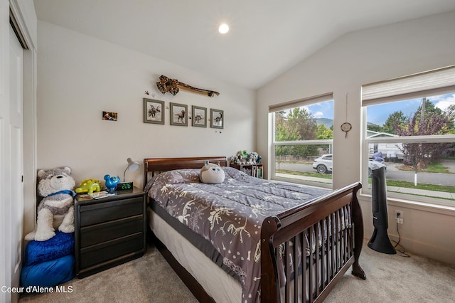 carpeted bedroom with lofted ceiling