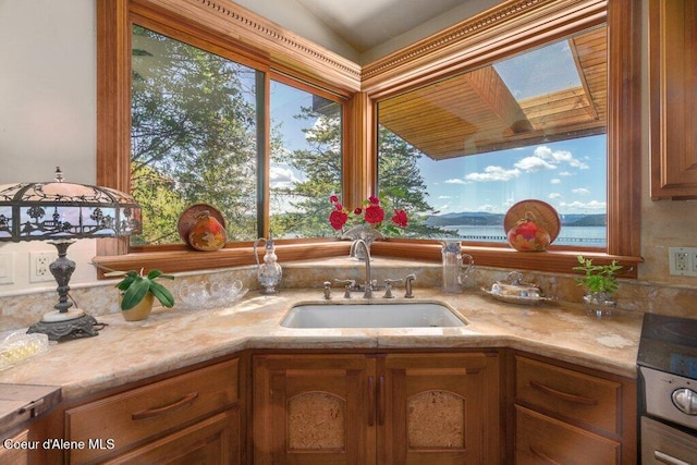 154 W Eagle Crest Dr, Sagle, ID 83860 - kitchen featuring a sink, brown cabinetry, and a skylight