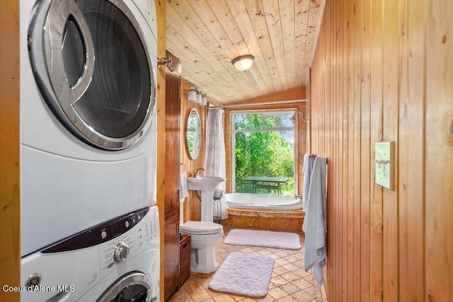 154 W Eagle Crest Dr, Sagle, ID 83860 - full bathroom with stacked washer and clothes dryer, lofted ceiling, wooden walls, wood ceiling, and a bathtub