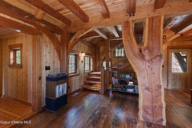 interior space featuring wood walls, hardwood / wood-style flooring, and a healthy amount of sunlight