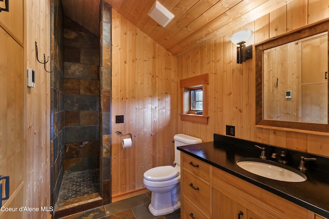 bathroom with a tile shower, toilet, wood ceiling, vanity, and lofted ceiling