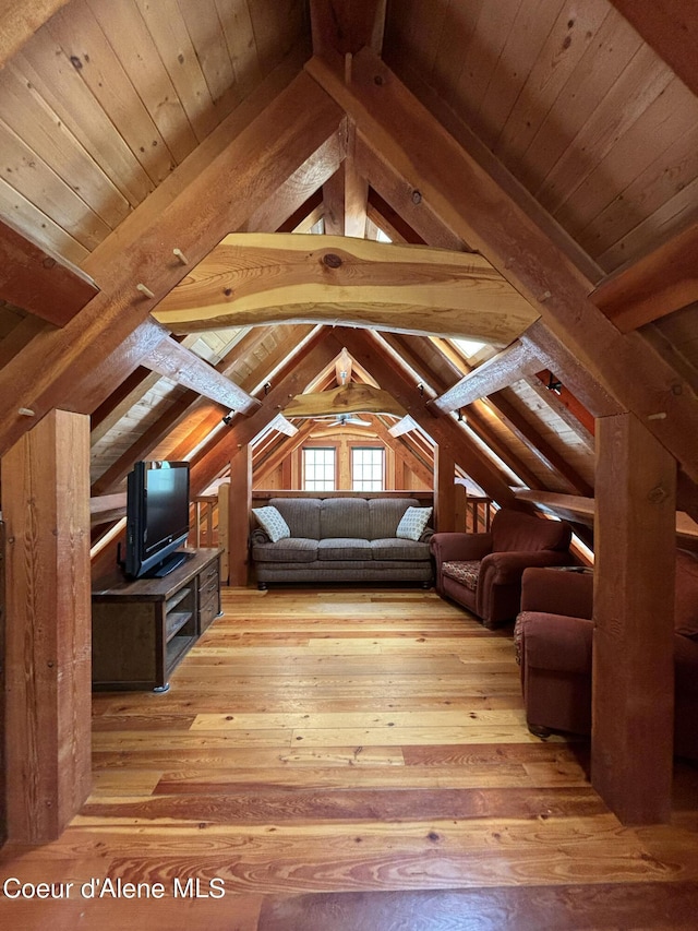 interior space featuring wood ceiling, hardwood / wood-style flooring, and lofted ceiling with beams