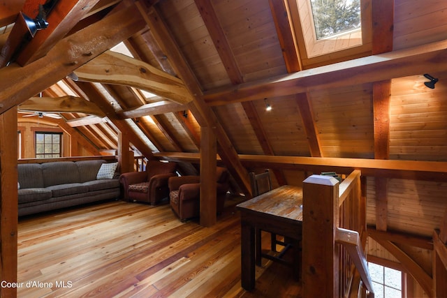 interior space featuring wooden ceiling, hardwood / wood-style flooring, vaulted ceiling with beams, and a healthy amount of sunlight