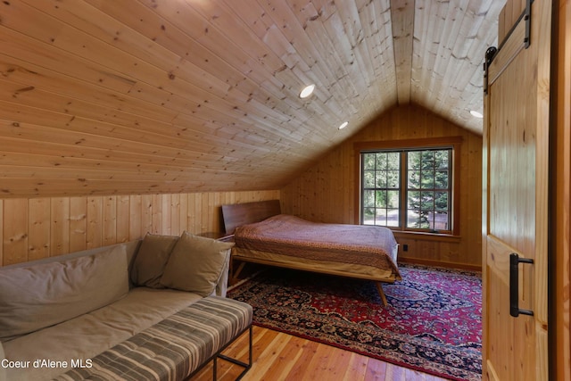 bedroom featuring wood walls, wooden ceiling, vaulted ceiling, and hardwood / wood-style flooring