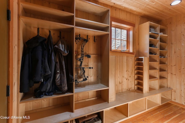mudroom with wooden walls, wood-type flooring, and wooden ceiling
