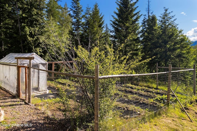 view of yard with an outdoor structure and fence